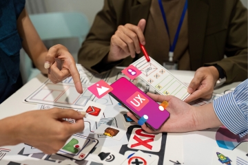 People collaborating on a UX design project with a